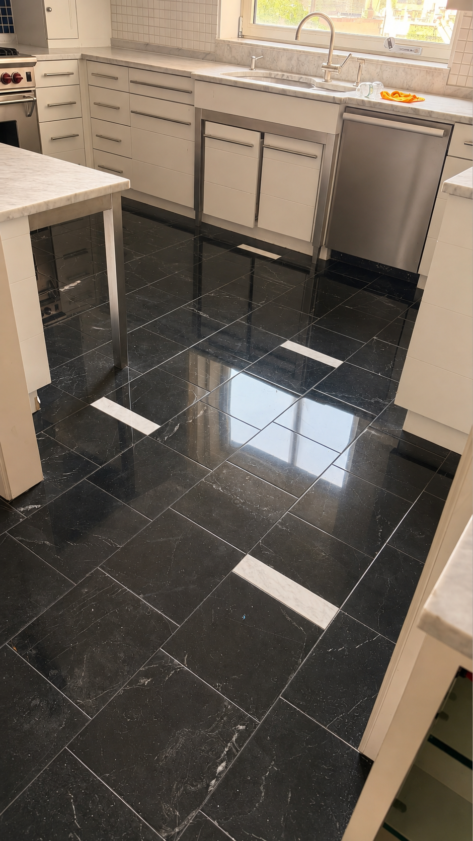 Restored Nero Marquina black marble kitchen floor with a high-gloss finish