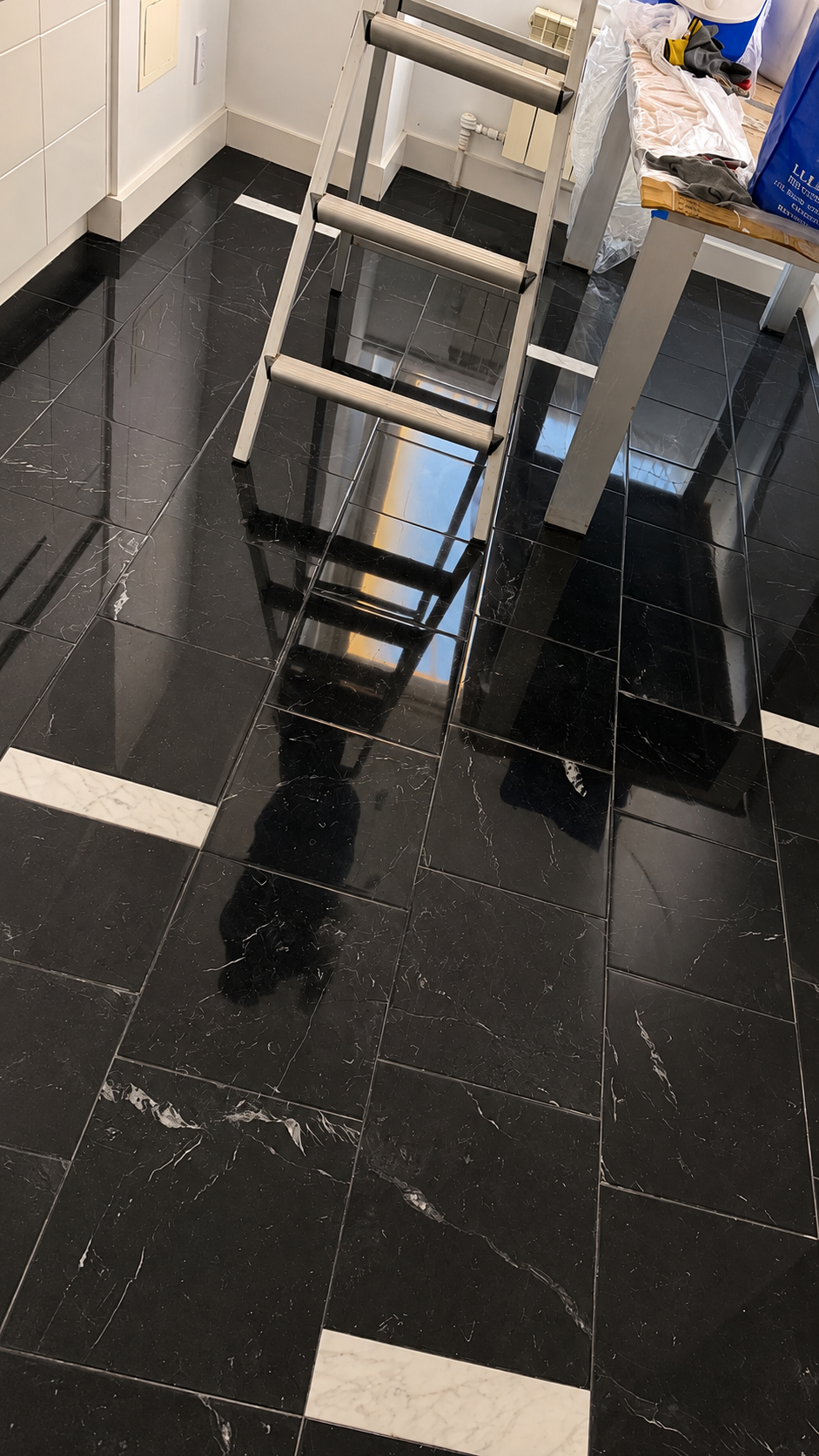 Polished Nero Marquina black marble kitchen floor after restoration