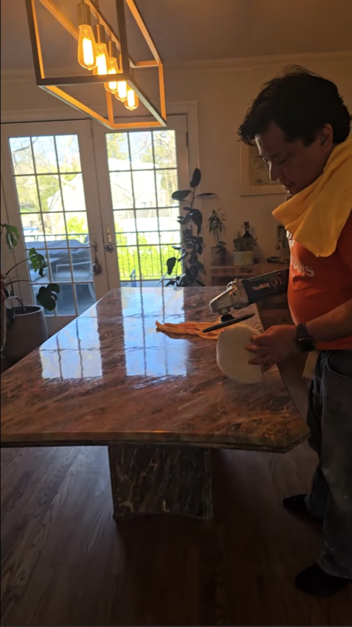 Stone Guys NY technician polishing a restored stone dining table to a reflective finish