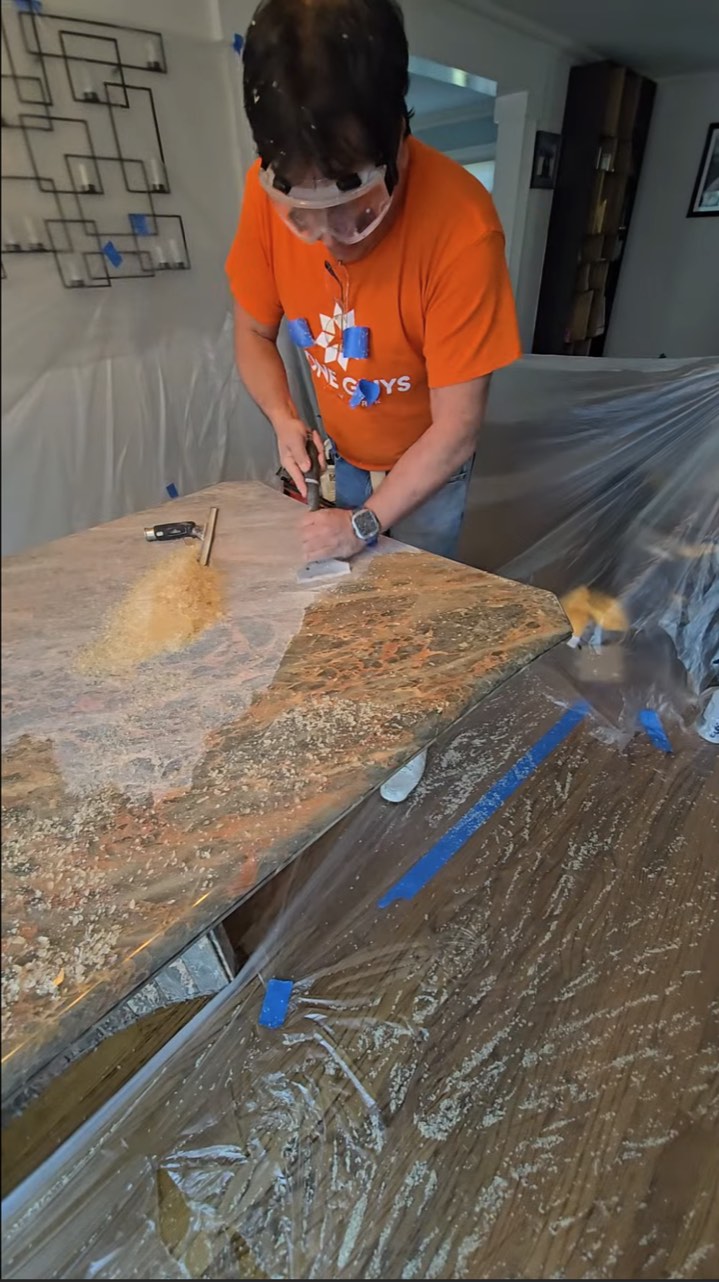 Stone Guys NY technician preparing a dining table after resin coating removal